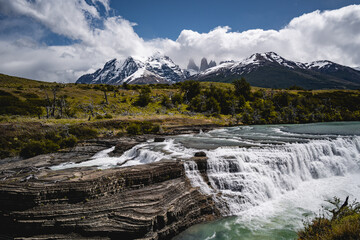 mountains under clouds and waterfall