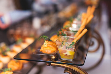 Beautifully decorated banquet catering table, with variety of with different food snacks appetizers...