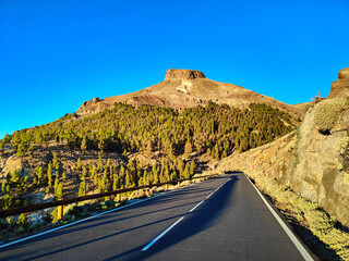A road to El Retamar mountain pass in El Teide National Park during the golden hour, Tenerife,...