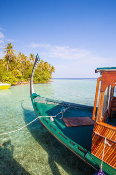 Traditional dhoni boat at shore in the Maldives