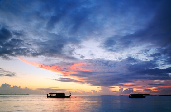 Dhoni traditional maldivian boat at sunset, Maldives