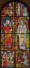 Foto op Plexiglas BERN, SWITZERLAND - JUNY 27, 2022: The St. Verena and St. Ida on the stained glass in the church Dreifaltigkeitskirche by A. Schweri (1938). © Renáta Sedmáková