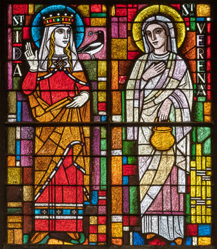 BERN, SWITZERLAND - JUNY 27, 2022: The St. Verena and St. Ida on the stained glass in the church Dreifaltigkeitskirche by A. Schweri (1938).