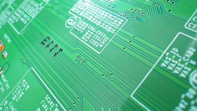 Dive into the microcosm of electronics as a Printed Circuit Board (PCB) tiny details come to life in stunning macro footage, a visual treat for tech enthusiasts. Electronic concept.
