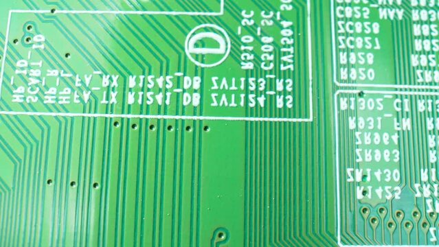 Step into the world of electronics with our macro video of a Printed Circuit Board (PCB). Dive into the labyrinth of traces and discover the heart of innovation. Close-up footage. Engineering concept.