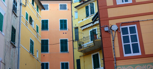 Fototapeta na wymiar Detail of colourful houses in the city centre of Lerici, bay of the poets, La Spezia, Liguria on a summer evening