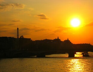 Sunset, Eiffel Tower and Paris cityscape silhouette reflecting on water of Seine river in Paris, France