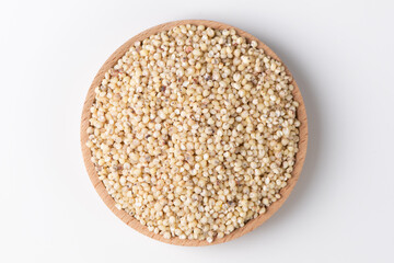Sorghum seeds in plate on white background. Whole seeds of Sorghum Moench
