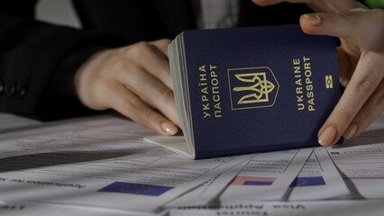 Close up shot of usa and europe union visa application documents. Female worker holding ukrainian...