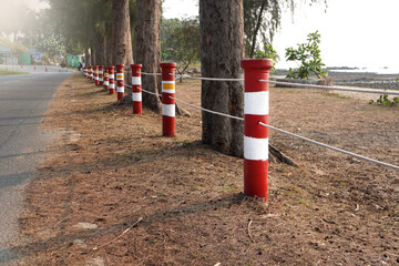 Fototapeta na wymiar Red and white fence posts mark the boundaries of the road.