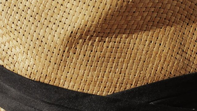 Texture of woven straw hat close-up. Headdress for vacation holidays. Sun hat