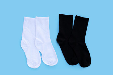 White and black socks on blue background.