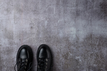 Gray background with pair black boots