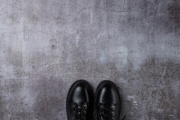 Gray background with pair black boots