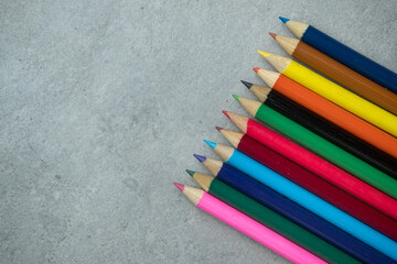 Brightly colored art pencils in a row. The concept of preschool and school education and hobbies