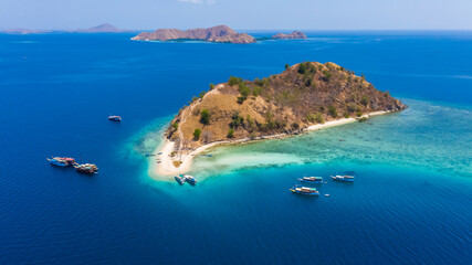 Fototapeta na wymiar Aerial view of beaches and tourist boat sailing in Kelor Island, Flores Island, Indonesia