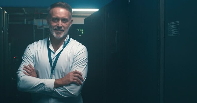 Man, server room and arms crossed for information technology, business cybersecurity or gdpr management. Face of senior technician in data center backup, cloud computing solution or night maintenance
