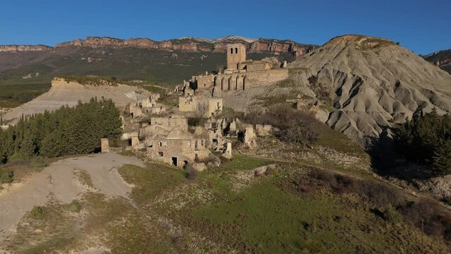 Ascending drone movement and revealing the abandoned village of Esc&oacute;, Spain