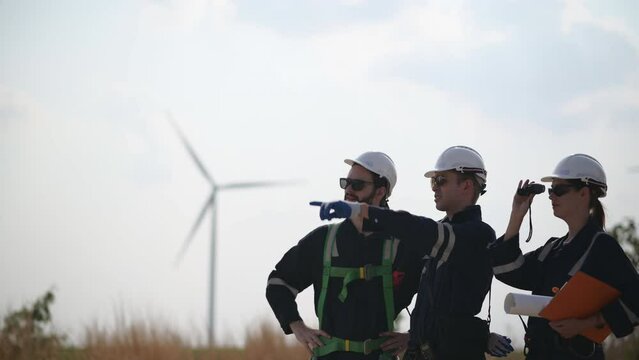Team of engineers working on site in wind turbine farm, Wind turbines generate clean energy source, Eco technology for electric, industry environment