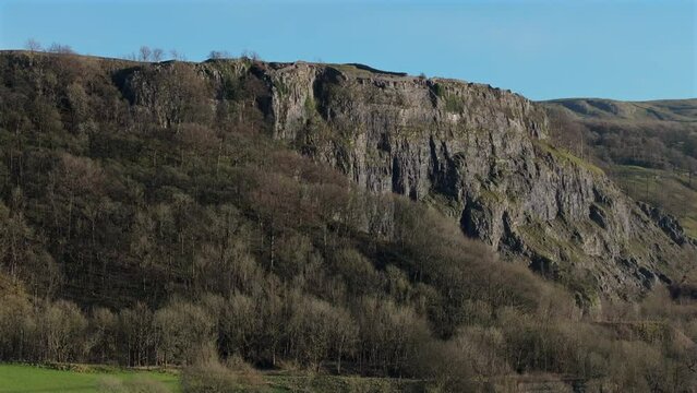 Establishing Drone Shot of Steep Cliff Rock Face and Trees Yorkshire
