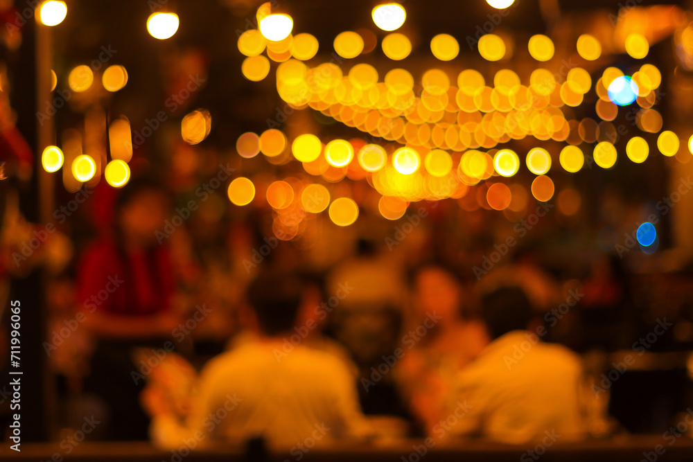 Poster blur image of night festival in a restaurant and the atmosphere is happy and relaxing with bokeh for