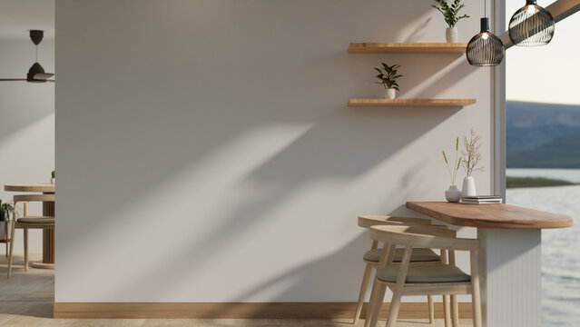 A modern, minimal cafe or restaurant with a minimal dining table near the large glass window.