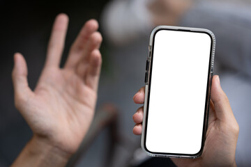 Close-up image of a dissatisfied man using his phone, unhappy with a lack mobile application.