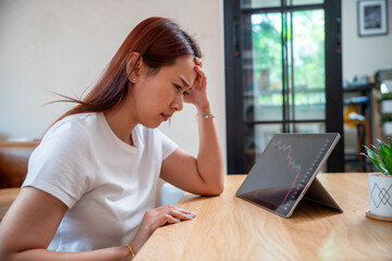 Stressed businesswoman feeling hopeless with stock market crisis, investment concept