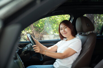 Naklejka premium Asian women driving a car and smile happily