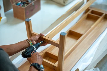 Foto op Plexiglas assembling furniture about repairing of wooden table. © nichapa