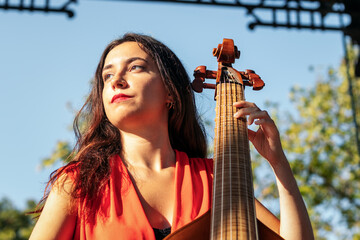 Woman musician playing cello outdoors - obrazy, fototapety, plakaty