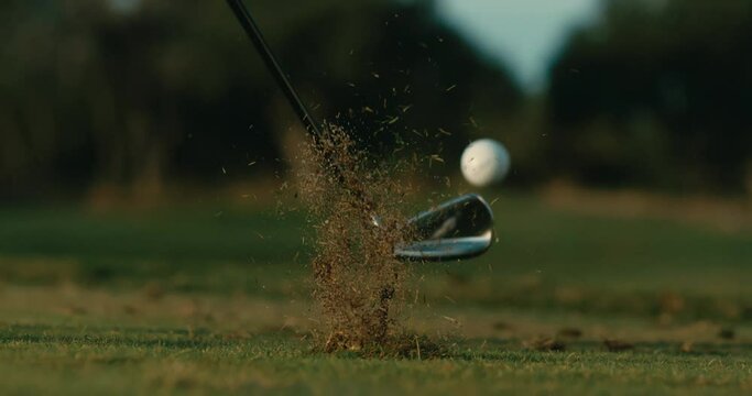 Slow motion golf shot from behind, wedge shot from tee on par 3, perfect ball flight on sunny day