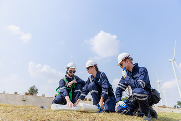 Team engineer wind turbine worker safety uniform survey discuss operational planning windmill field clean energy. Alternative technology protect environment reduce global warming problems.