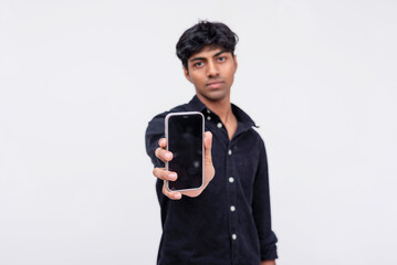 Fototapeta premium Young man presenting smartphone with blank screen