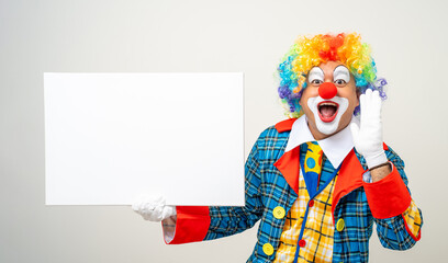 Mr Clown. Portrait of Funny face Clown man in colorful uniform standing holding copy space. Happy expression male bozo in various pose with frame mockup blank space on isolated background.