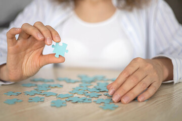 Business woman hands assembling puzzle details concept of finding solution solving problem top view
