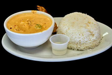 Side view of Thai traditional spicy Red curry with chicken and streamed rice