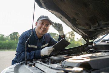 Professional car mechanic maintenance vehicle. The mechanic opens the front of the car. Checking...