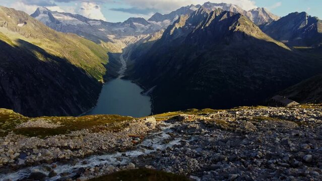 Downward drone shot to the "Panoramabr&uuml;cke" a famous suspension bridge with a stunning view of Schlegeis Stausee below