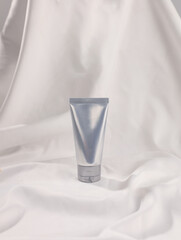 unmarked brand tube product on white silk background