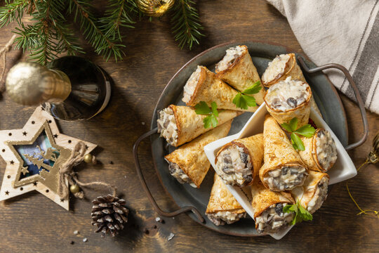 Creative appetizers christmas. Lavash roll cone with chicken and mushroom salad on a plate. Top view, flat lay.