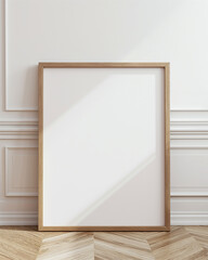 mockup of a blank large light oak frame leaning against a white wall.