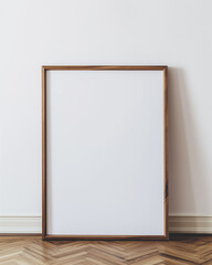 mockup of a blank large light oak frame leaning against a white wall.