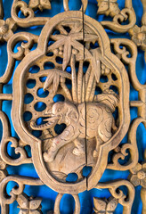 A close-up of traditional decorative patterns carved on wooden doors of ancient Chinese buildings