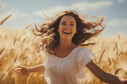 young happy girl running and jumping carefree with open arms over wheat field