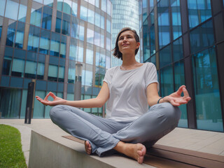 De-stress, unwind idea. peaceful female freelance employee practicing yoga exercises while sitting...