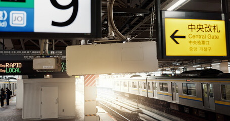 Railway platform, train and signs with Japanese for commute, travel or journey and transportation....