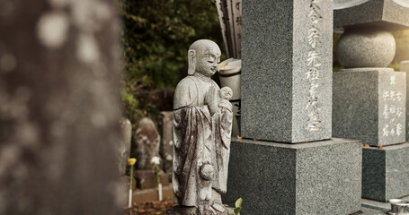 Buddha, statue and tombstone in graveyard with culture for safety, protection and sculpture outdoor...