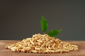 Heap of wooden pellets biofuel on wooden table