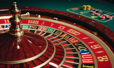 Naklejka premium close up of bright multicolored casino roulette table with poker chips